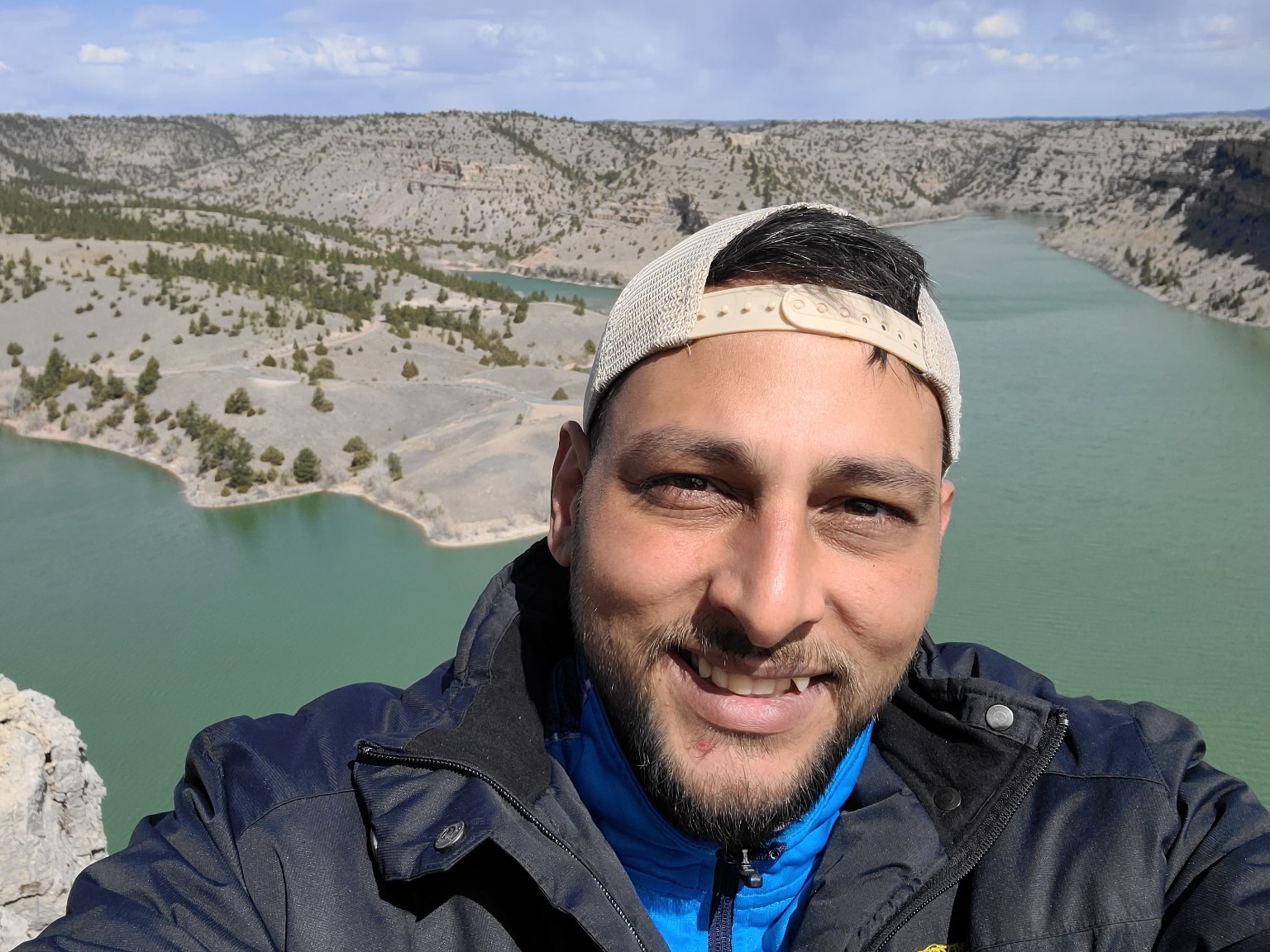 Tim overlooking a turquoise reservoir at Guernsey State Park in Wyoming.